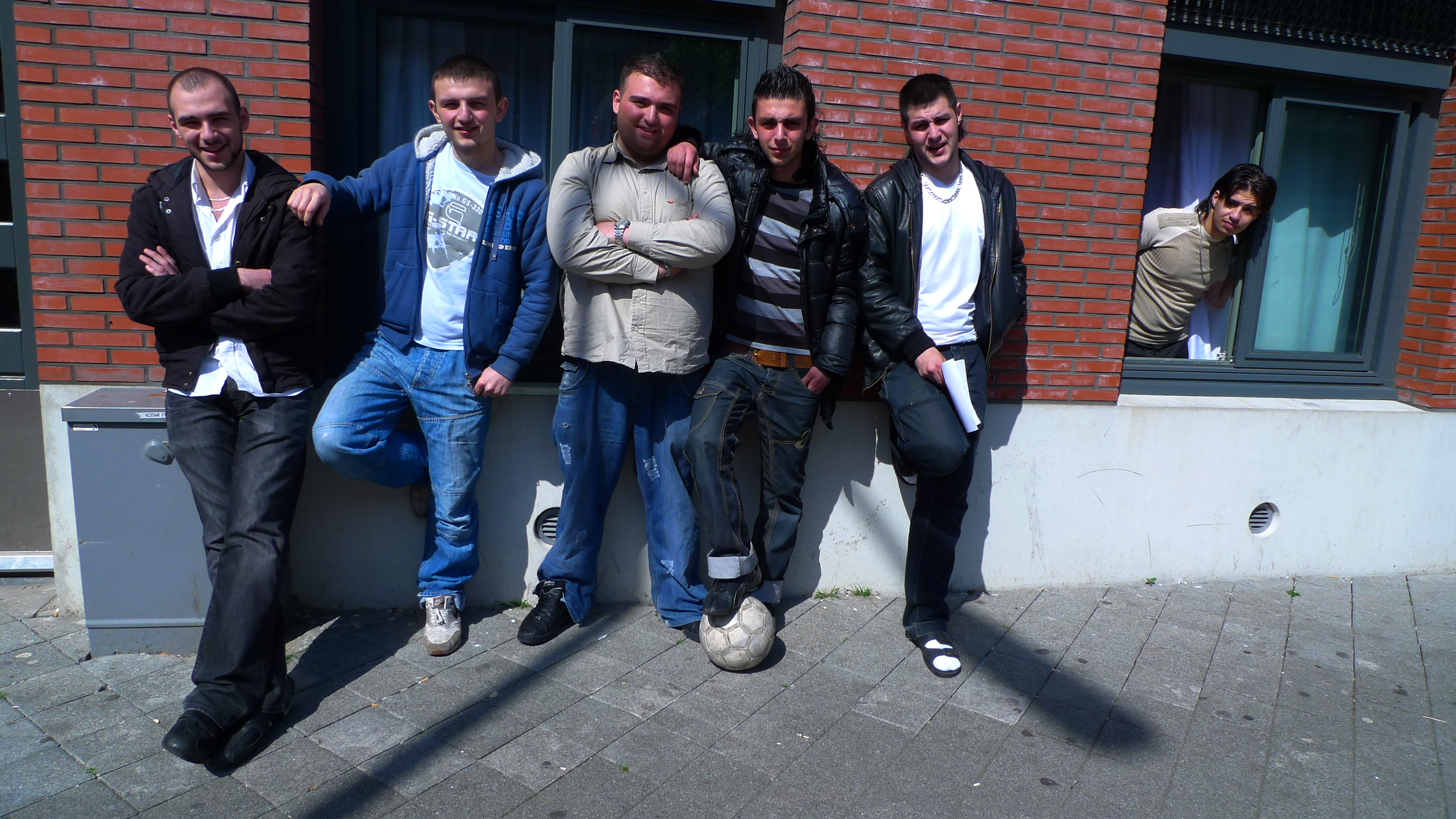 This is a photo of a group of Dutch youths leaning against the wall of their families apartments in the Den Haag's Schilderswijk. I shot this photo during my research into this neighbourhood for a food-systems related project, Foodscape Schilderswijk.
